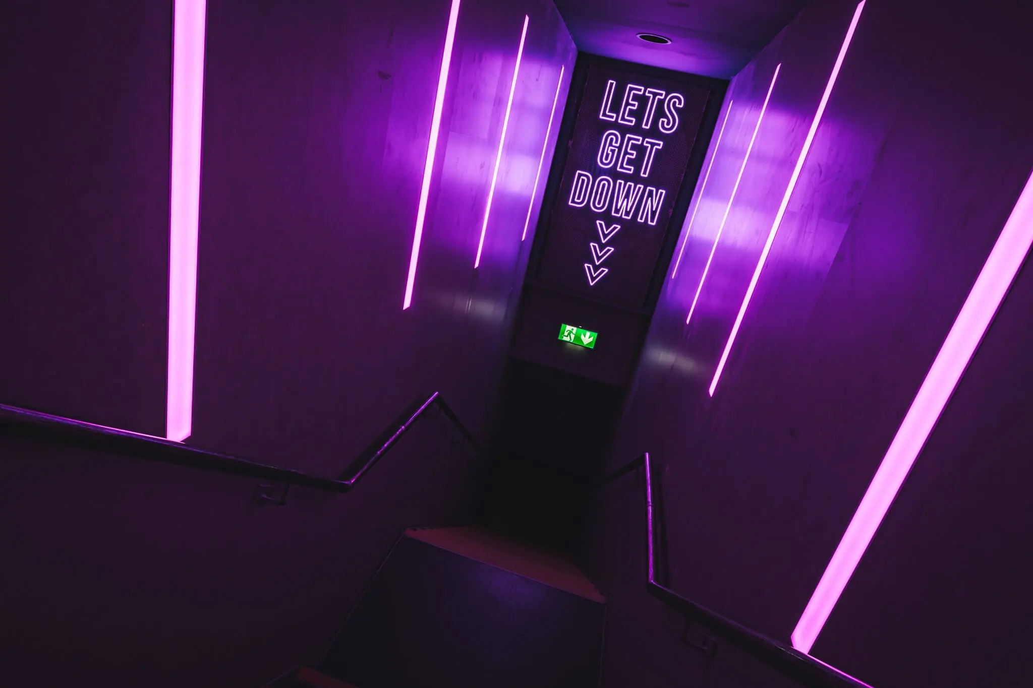 The Studio at Thompsons, an intimate room lit in purple neon